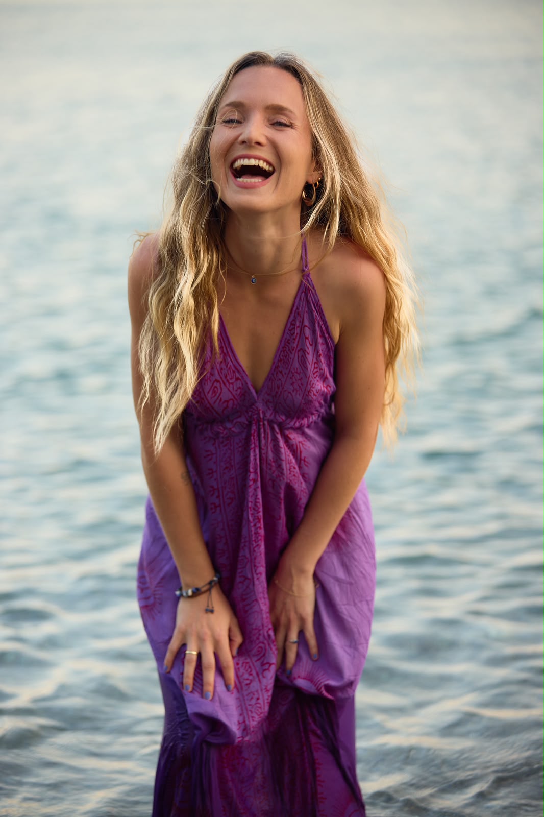 Elise Fonck standing joyfully by the water