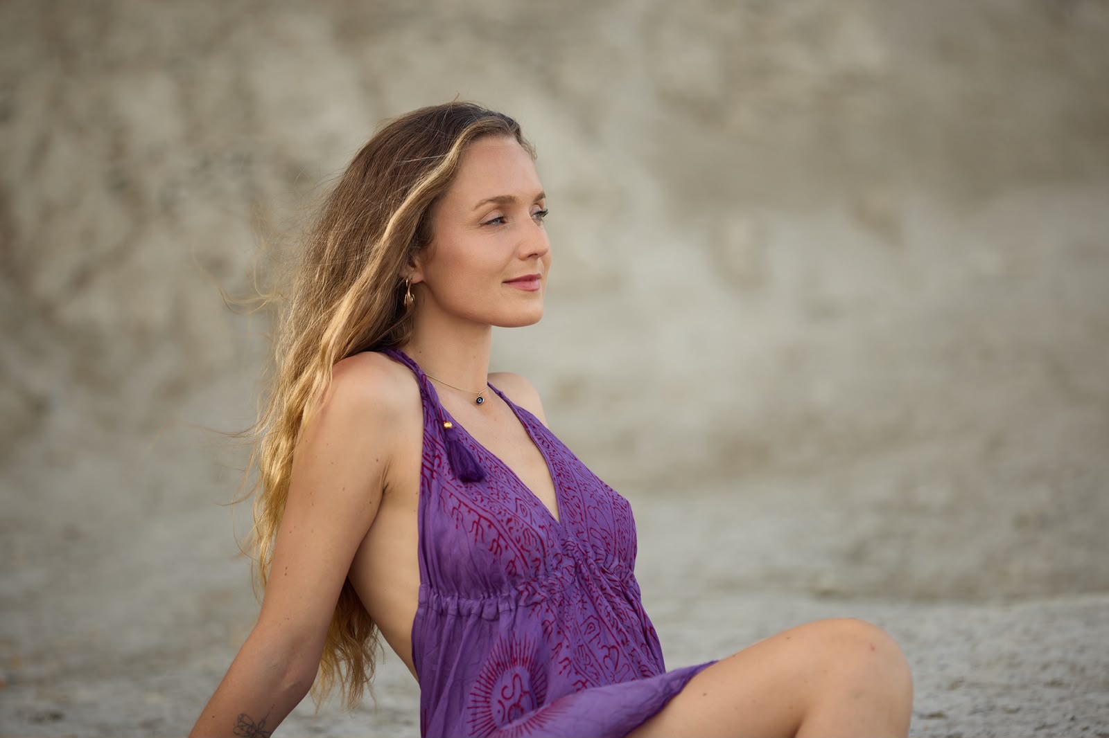 Elise seated on the sand
